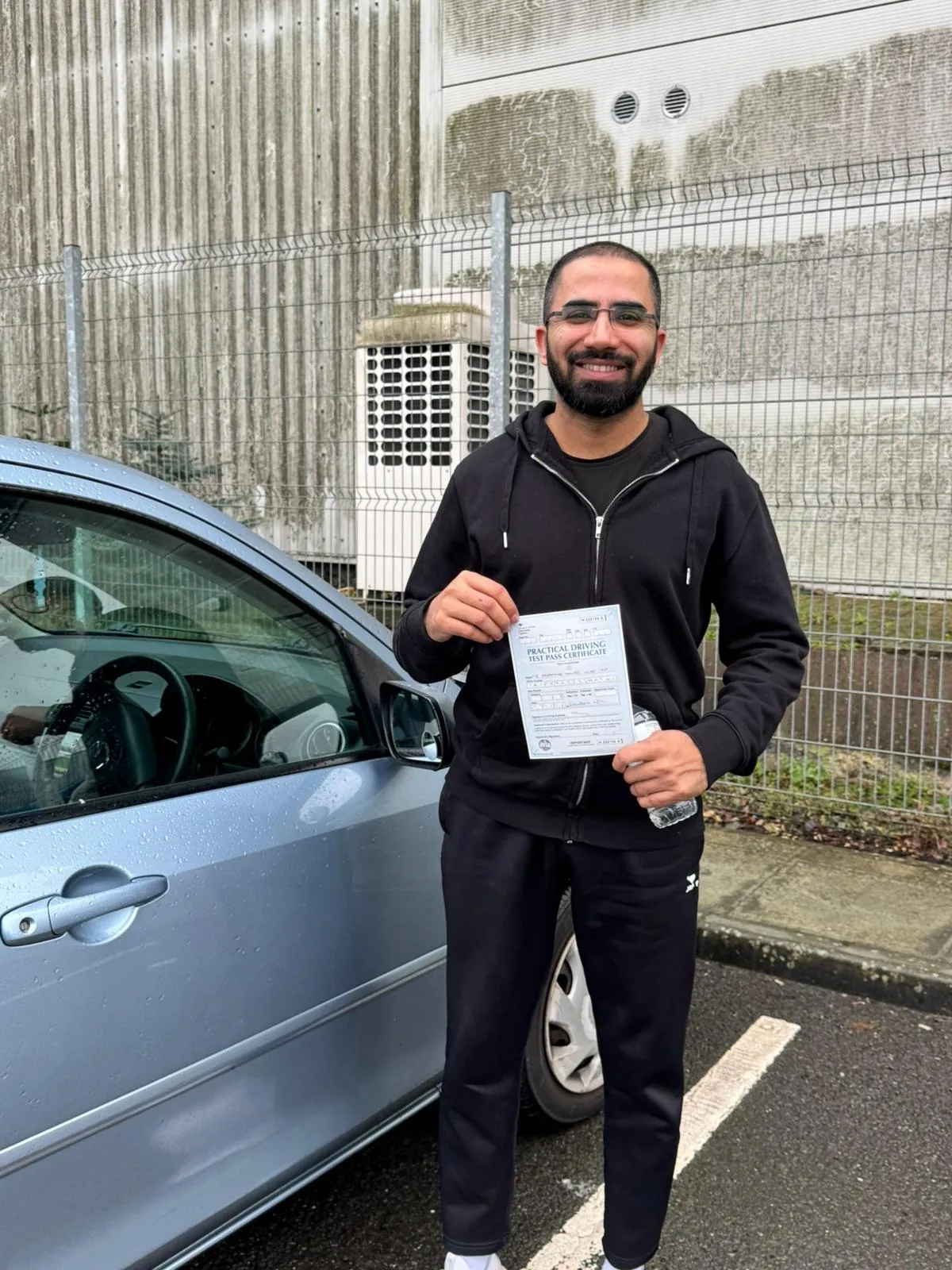 Pupil with his driving test pass certificate