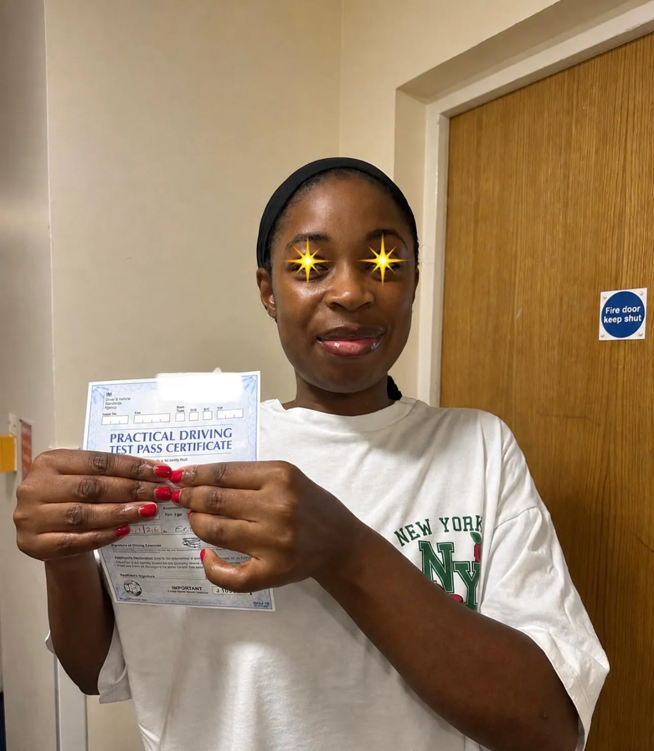 Pupil holding her practical driving test pass certificate