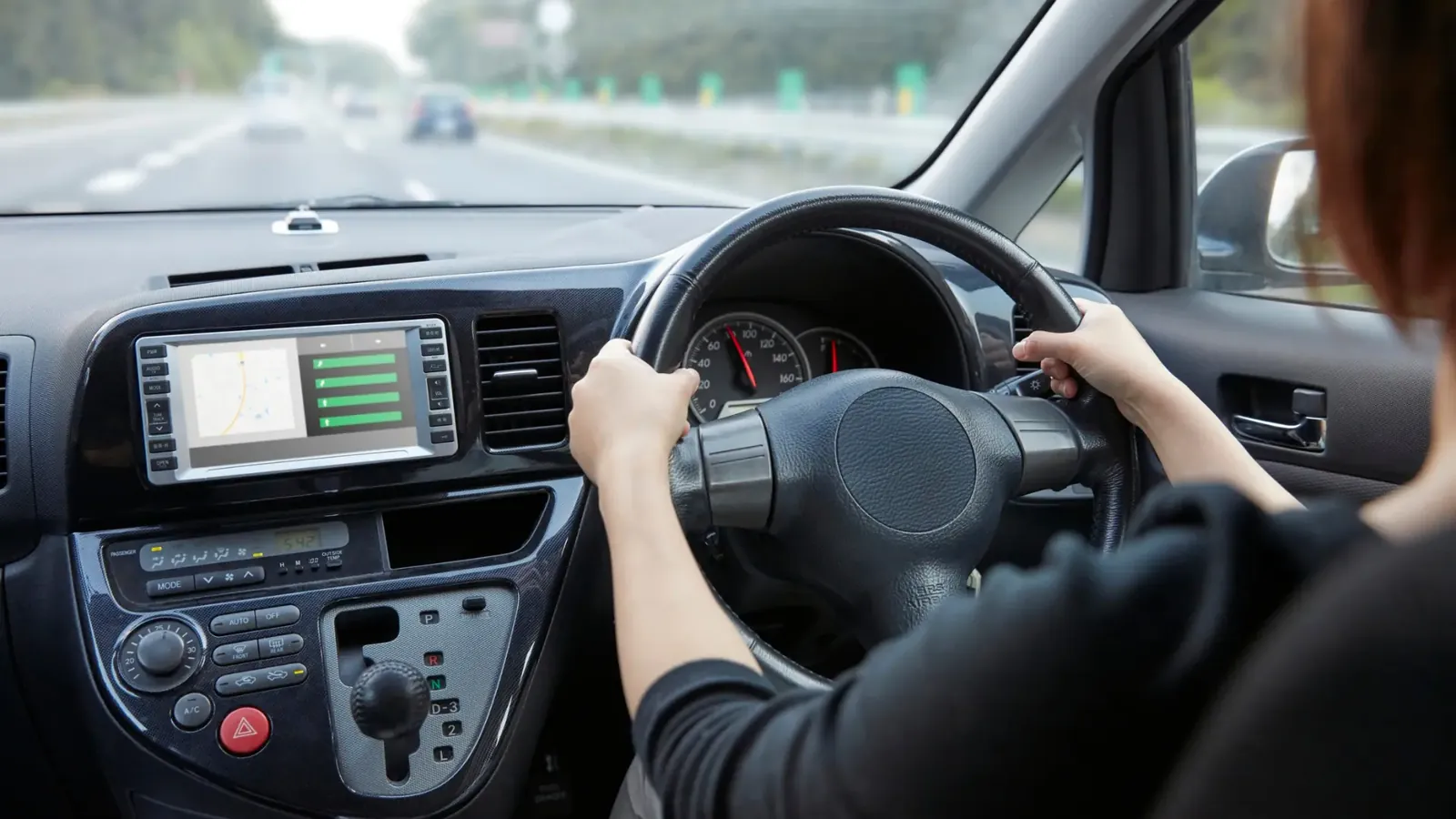 Learner driver's hands on the steering wheel of an automatic car