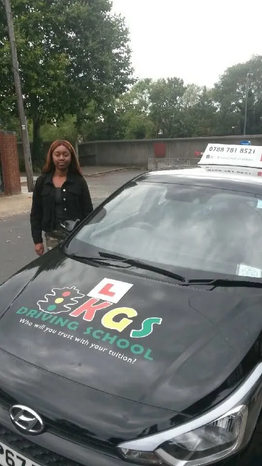 Pupil beside the KGS Driving School car after her driving test