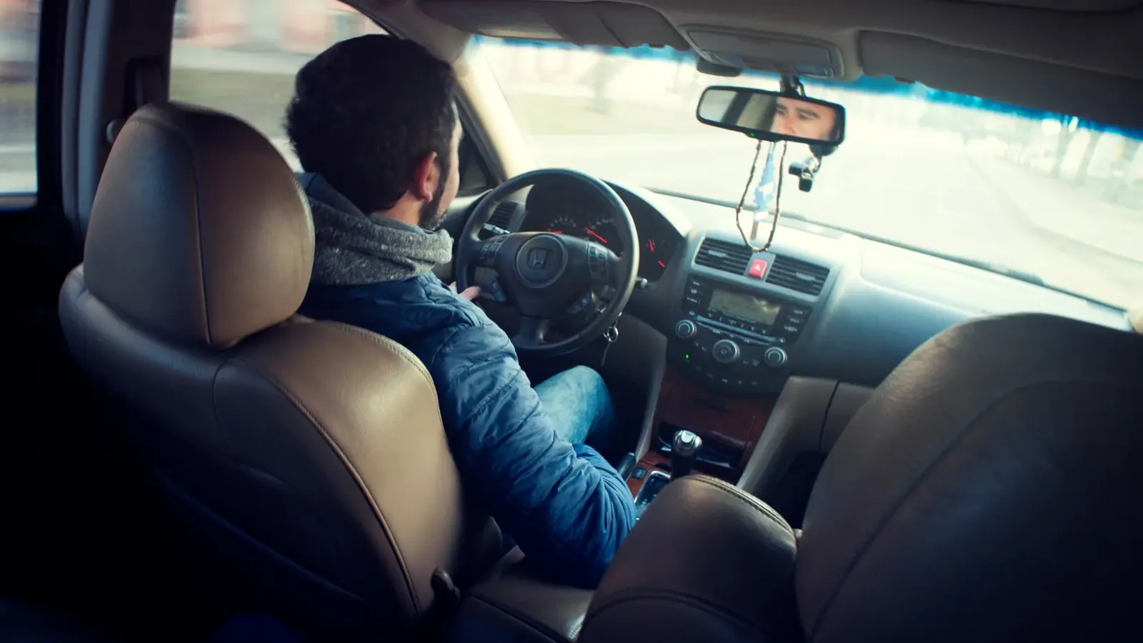 Driver back behind the wheel on a refresher driving lesson